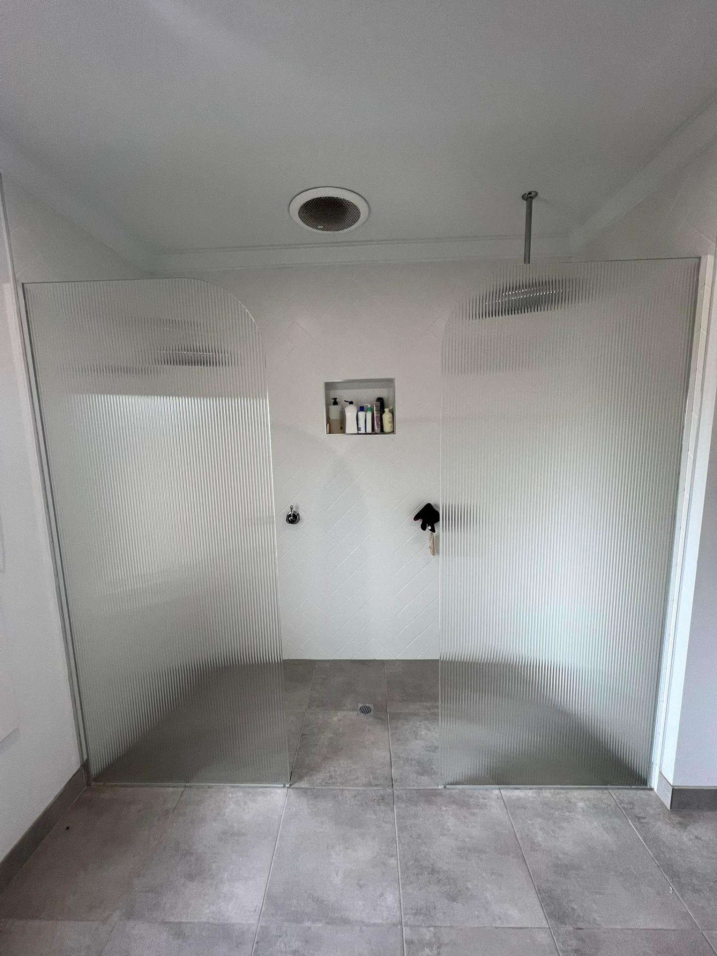 Custom frameless shower screen with matte black hardware